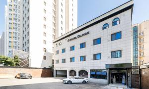 a white car parked in front of a building at Hotel Salmon in Seoul