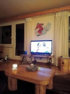 a living room with a tv and a coffee table at Spacious Apartment in Lens with Mountain View in Lens +39 photos