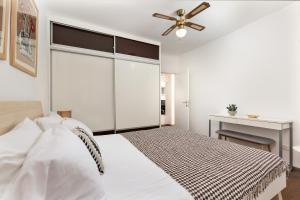 a bedroom with a bed with a ceiling fan at Apartment Lassy by Irundo in Rovinj