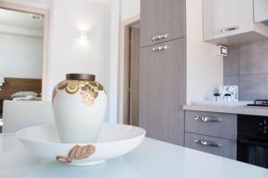 a white vase sitting on a white counter in a kitchen at Casa Corvaja in Taormina