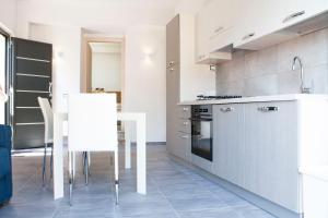 a kitchen with stainless steel appliances and a table at Casa Corvaja in Taormina