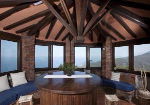 a living room with a table and some windows at Torre Rivolta in Orbetello