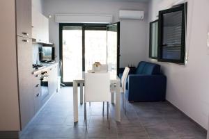 a small kitchen with a table and a blue couch at Casa Corvaja in Taormina