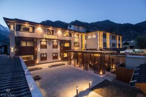 a hotel with a large patio with lights on it at Paradise Hotels in Pahalgām
