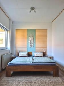 a bedroom with a bed and a chandelier at House of Flow in Pritzwalk