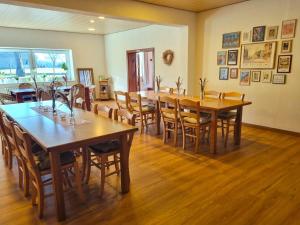 a dining room with wooden tables and chairs at House of Flow in Pritzwalk