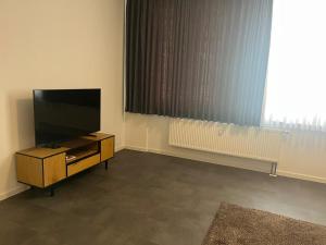 a living room with a flat screen tv and a window at Ferienwohnung Alina in Werne an der Lippe