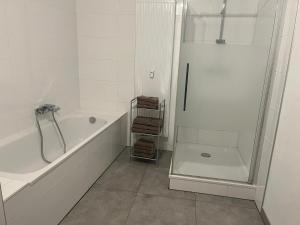 a white bathroom with a tub and a shower at Ferienwohnung Alina in Werne an der Lippe