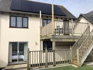 a house with solar panels on the roof at Kernow House in Croyde