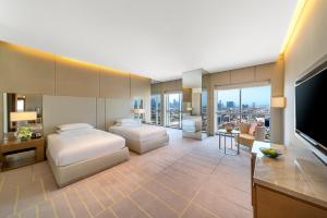 a hotel room with two beds and a flat screen tv at Hyatt Regency Dubai Creek Heights in Dubai