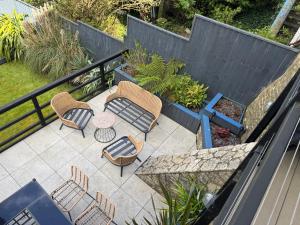 an outdoor patio with chairs and a table and a fence at Clements House Swanage in Swanage