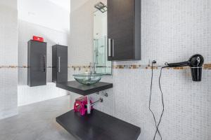 a bathroom with a bowl sink and a blow dryer at Casa Dudú in Quartucciu +17 photos