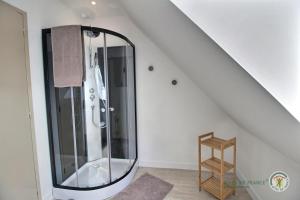 a bathroom with a glass shower in the attic at Ker'luane in Lézardrieux +40 photos