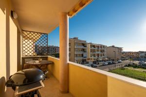 a balcony with a grill and a view of a city at Casa Dudú in Quartucciu