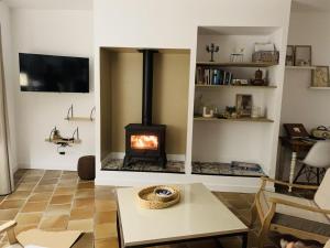 a living room with a wood stove in a room at Ker'luane in Lézardrieux