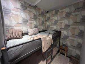 a room with a bed in a room with a wall at La Vida in Lanaken