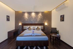 a bedroom with a large bed in a room at Hotel Hemaadri Grand in Hyderabad
