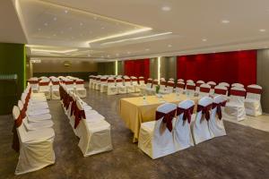a banquet hall with rows of tables and chairs at Hotel Hemaadri Grand in Hyderabad