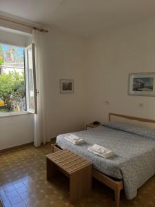 a bedroom with a bed and a window at Miramaretellaro in Tellaro