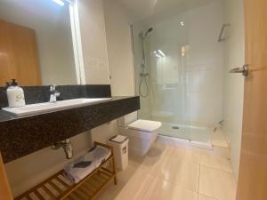 a bathroom with a sink and a toilet and a shower at Apartament Sara in L'Eucaliptus +24 photos