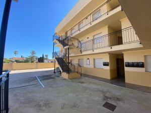 a large building with stairs in a parking lot at Apartament Sara in L'Eucaliptus