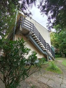 a staircase on the side of a building with trees at Harbor Hideaway Balatonfüred in Balatonfüred