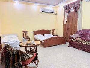 a room with two beds and a table and a couch at Garden EVN Airport 5 min from Airport in Pʼarakʼar