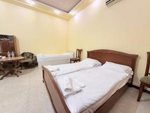 a bedroom with two beds and a table in it at Garden EVN Airport 5 min from Airport in Pʼarakʼar