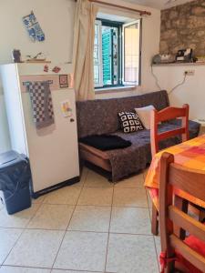 a living room with a couch and a refrigerator at Stone House - Waterfalls, Nature Stay in Louriçal do Campo