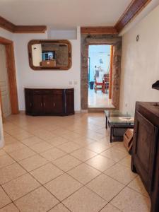 a living room with a mirror and a tiled floor at Stone House - Waterfalls, Nature Stay in Louriçal do Campo