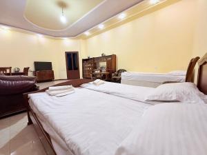 a room with two beds and a living room at Garden EVN Airport 5 min from Airport in Pʼarakʼar