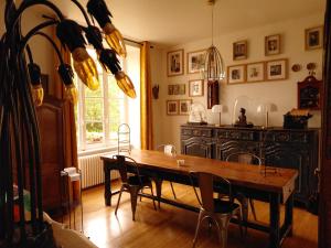 a dining room with a wooden table and chairs at Le Banellou in Quimper +36 photos