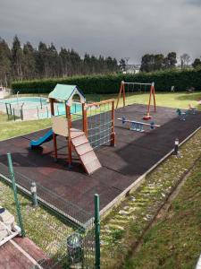 a park with a playground with a slide at Apartamento Jurásico in Barreiros