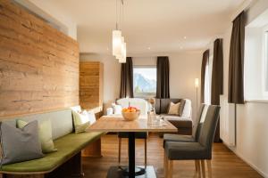 a living room with a table and a couch at Haus Schönblick in Seefeld in Tirol