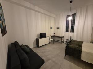 a bedroom with a bed and a desk with a television at Casetta della Lupa in Cernusco sul Naviglio