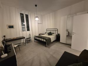 a bedroom with a bed and a table and a desk at Casetta della Lupa in Cernusco sul Naviglio