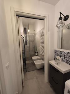 a bathroom with a shower and a sink and a toilet at Casetta della Lupa in Cernusco sul Naviglio