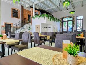 a dining room with tables and chairs and a staircase at Penzión Wellness & Restaurant Zoborská, free parking in Nitra