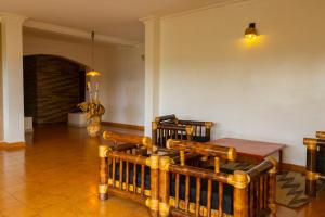 a dining room with wooden chairs and a table at UmuTea Villa - Authentic East African local experience in Kigali