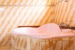 a bathroom with a sink in a tiled wall at UmuTea Villa - Authentic East African local experience in Kigali