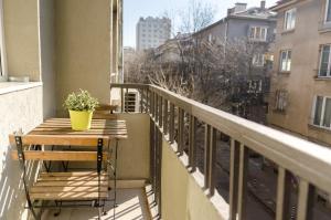 a balcony with a table with a plant on it at VIP Apartments Sofia in Sofia
