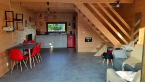 a kitchen and a living room with a table and chairs at Domki Dobrogoszcz in Dobrogoszcz