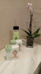 a table with two towels and a vase with a flower at Despertar in Antequera +17 photos