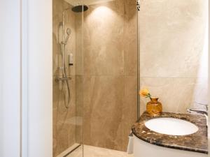 a bathroom with a sink and a shower at Hotel Kaiserhof Wien in Vienna