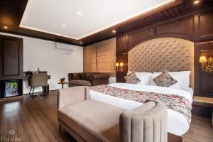 a hotel room with a bed and a couch at Paradise Hotels in Pahalgām