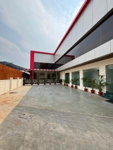 an empty parking lot in front of a building at Hotel Aura Inn in Dehu