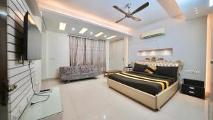 a bedroom with a bed and a television in it at Rustam Villa Sector 39 in Gurgaon