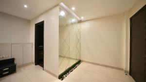a walk in closet with a glass wall at Rustam Villa Sector 39 in Gurgaon +58 photos
