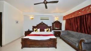 a bedroom with a bed and a couch at Rustam Villa Sector 39 in Gurgaon