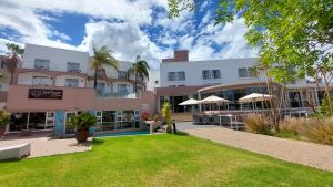 a large building with a lawn in front of it at Protea Hotel by Marriott Windhoek Furstenhof in Windhoek